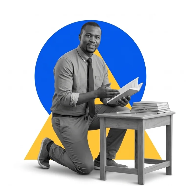 A teacher kneeling beside a school desk with an open book